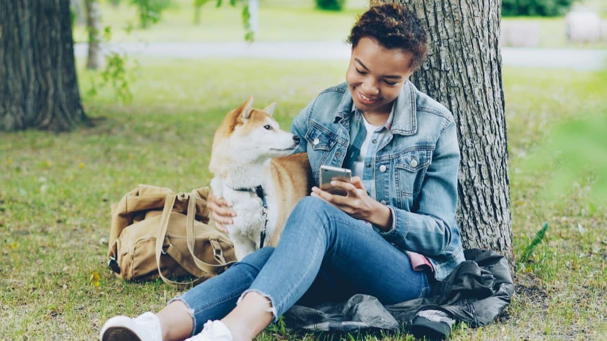 A woman outdoors checking her phone